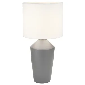 Lámpara de sobremesa con base de cerámica en cuatro colores y pantalla de tela blanca. Aporta una luz cálida y acogedora ideal para salones y dormitorios, con un diseño elegante y sofisticado.